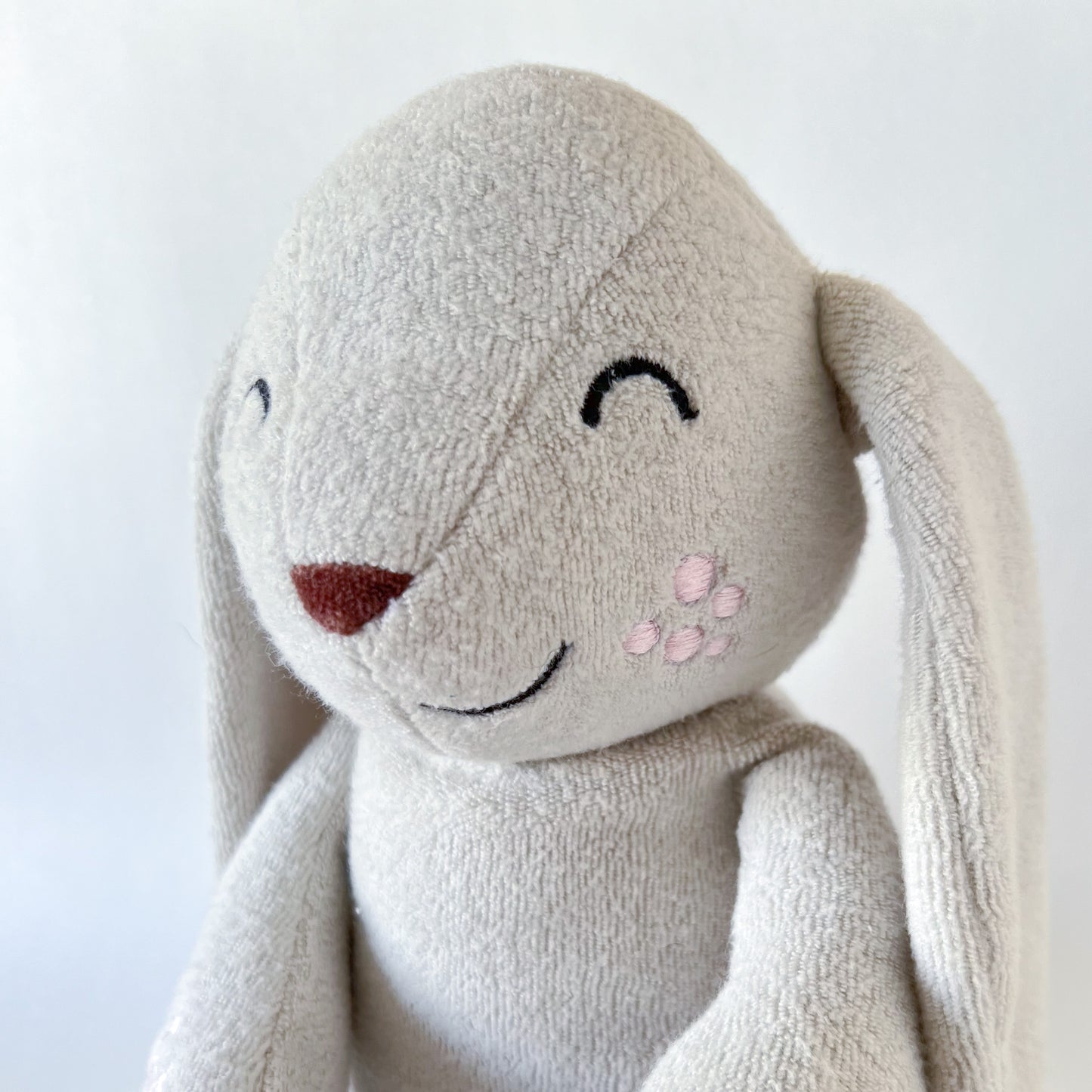 bunny stuffed animal close up face shot with embroidered features