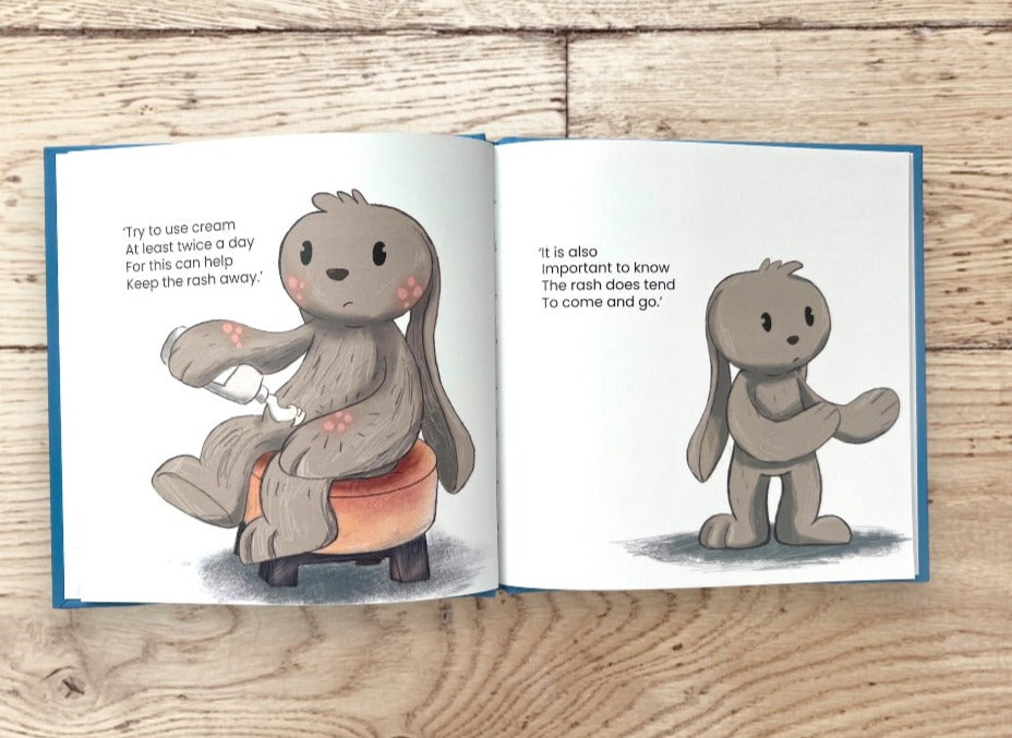Sneak preview of two inside pages of a children's book titled Biscuit's Eczema Journey. Left page reads: try to use cream at least twice a day for this can help keep the rash away. Right page reads: It is also important to know the rash does tend to come and go.