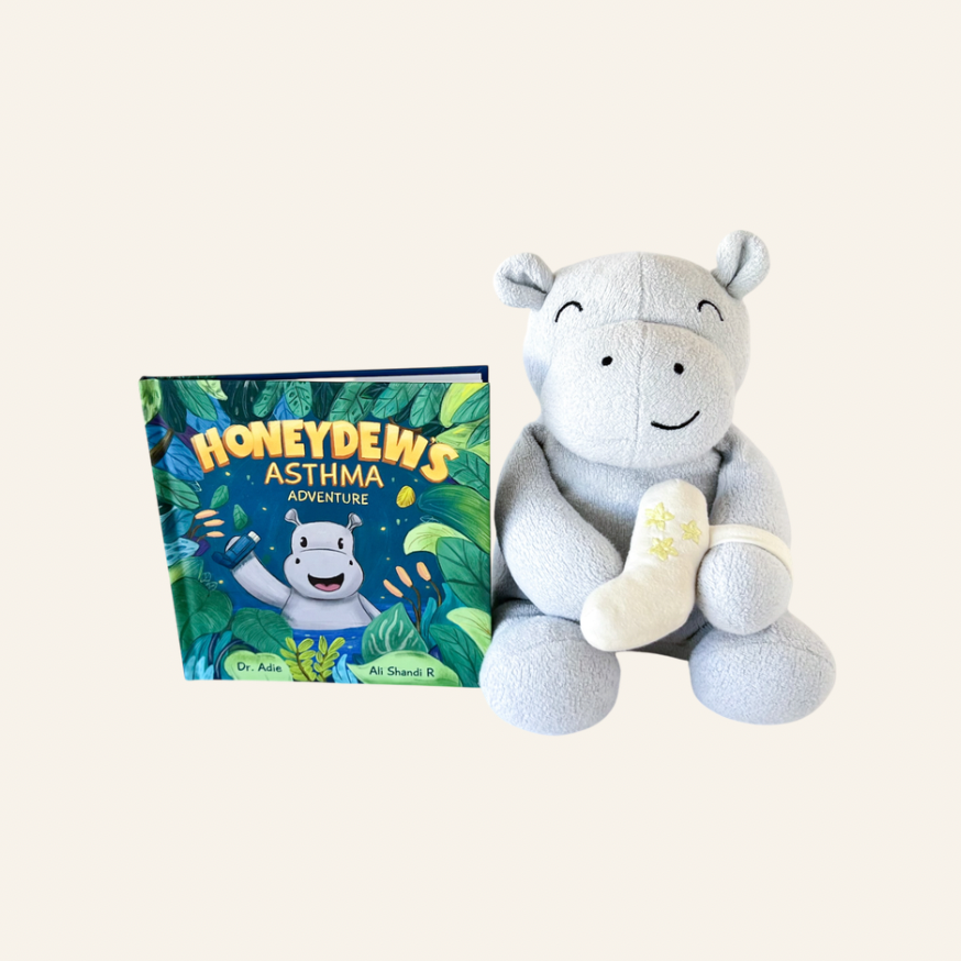Plush hippo toy next to a children's book titled 'Honeydew's Asthma' on a white background
