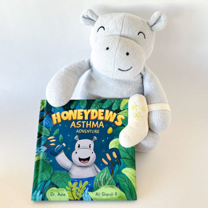 Stuffed animal hippo Honeydew holding her book titled Honeydew's Asthma Adventure